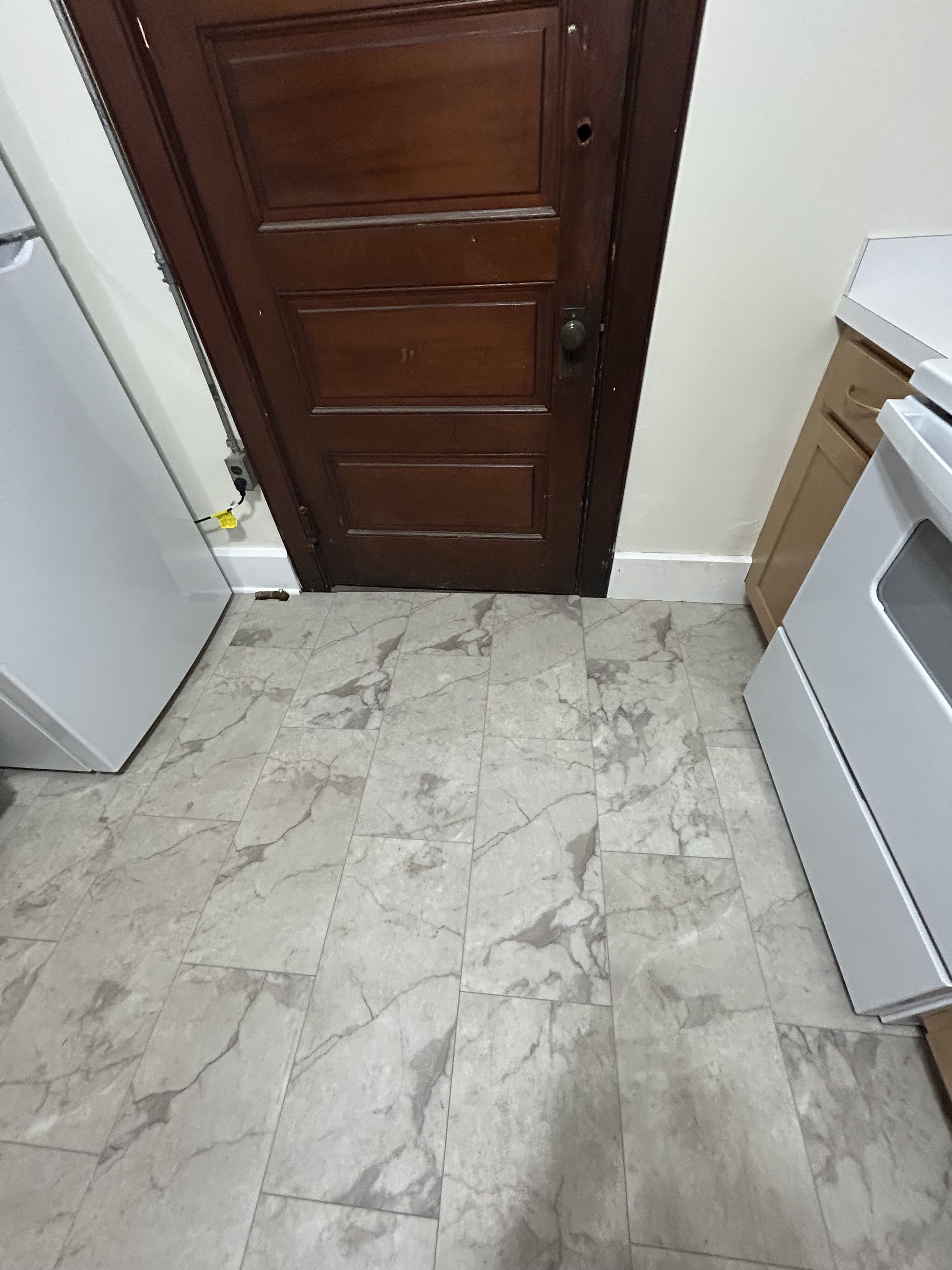 New marble-look tile flooring in the renovated kitchen